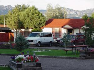a white van parked in front of a house at Bryce Canyon Motel in Panguitch