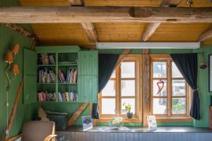 a room with a book shelf and a window at Heimbrygga Restaurant & Accommodation in Skrova