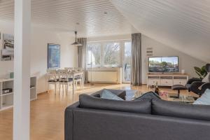 ein Wohnzimmer mit Couch und ein Esszimmer in der Unterkunft 50187... in Harlesiel