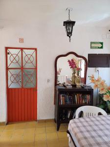 a room with a red door and a book shelf at Hotel Ana Liz in Puerto Vallarta