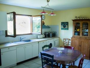 a kitchen with a table and a sink and a window at Gîte Le Mayet-de-Montagne, 4 pièces, 6 personnes - FR-1-489-317 in Le Mayet-de-Montagne