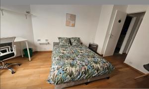 a bedroom with a bed and a desk and a television at The Lake House rooms - 20 min to Paris by metro in Créteil