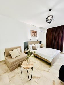 a bedroom with a large bed and a couch at Hotel Lagadin in Ohrid