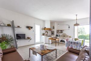 a living room with a couch and a table at Villa Ginevra by Villa Plus in Ispica