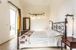 a bedroom with a bed and a dresser and a window at Villa Ginevra by Villa Plus in Ispica +10 photos