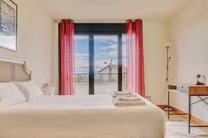 a bedroom with a bed and a large window at Casa Viana by Clabao in Viana +40 photos