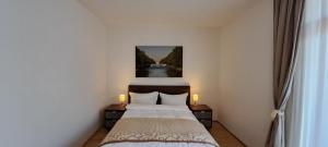 a bedroom with a bed and two candles on tables at Westpark Apartments in Munich