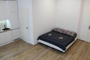 a small bedroom with a bed and a mirror at Park Tower apartment v centru Zlína in Zlín