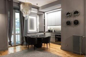 a kitchen with a table and chairs and a chandelier at Rome Bridge Apartment in Rome