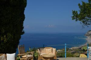 a view of the ocean from a patio with chairs at Gioiosa Marea Appartamento per 4 con vista sulle Eolie Casa Spisidda "Panarea" in Gioiosa Marea