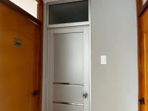 a white cabinet with a window in a room at HOSTAL SANTA ISABEL-JAUJA in Jauja