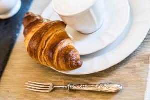 a plate with croissants and a cup of coffee at Villa9centob&b in Castel di Lama