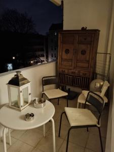 a balcony with a table and chairs and a cabinet at Wohnung in Berliner Innenstadt in Berlin