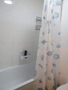 a bathroom with a white tub and a shower curtain at Wohnung in Berliner Innenstadt in Berlin