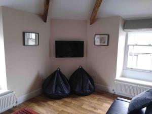 a living room with two black bags on the wall at The Penthouse - in the heart of Sedbergh in Sedbergh