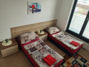 a room with two beds and two tables in it at Apartmán Štefánikova in Zlín
