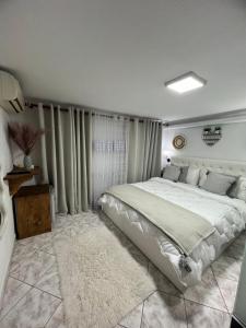 a bedroom with a large bed and a rug at Himalayas in Gjirokastër