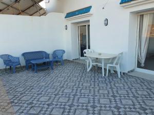 a patio with chairs and a table in a building at Stunning Penthouse with Sea and Castle View (2BDR) in Sousse