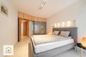 a bedroom with a large bed in a room at VOKEY Studio 05 - City Center in Jastarnia