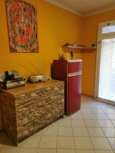 a kitchen with a red refrigerator and a counter at Casa Viarago in Pergine Valsugana