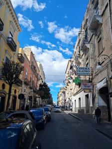 a city street with cars parked on the side of the road at Casa Politeama Spacious Central Flat by Oplonti Station for Pompeii, Sorrento and Naples in Torre Annunziata