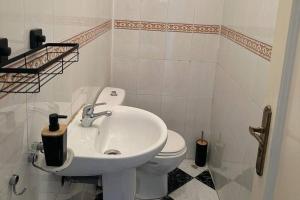 a bathroom with a white sink and a toilet at Beautiful Sea View Apartment in Tangier in Tangier