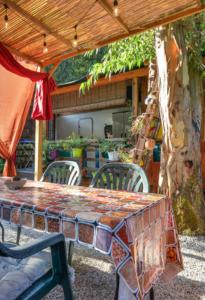 a table and chairs under a patio umbrella at Chalet nel Verde di Cavo in Cavo