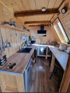 a large kitchen with a large wooden counter top at Triangle House Parang in Petroşani