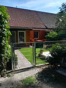 a gate in front of a house at Ferienwohnung Am Wald in Michendorf