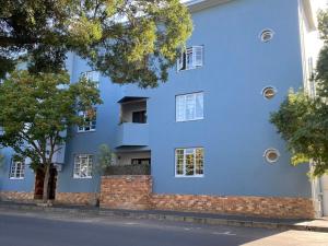 a blue house on the side of a street at Stay on Main - Studio Blue in Paarl