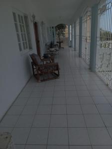 an empty hallway of a house with chairs and tables at OCEANView in Montego Bay
