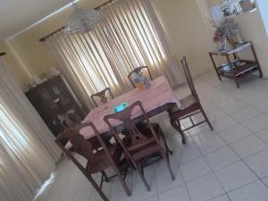 a pink table and chairs in a room at OCEANView in Montego Bay
