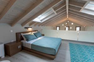 a bedroom with a bed in a room with wooden ceilings at Akti Vigla Apartments in Mytilini