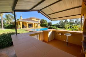 an outdoor kitchen with a view of a house at Villa El Higueral in Marbella