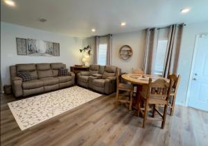 a living room with a couch and a table at Lakeside Motel, Cabins and RV in Kingston