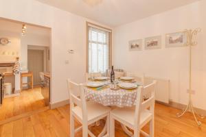 a kitchen and dining room with a table and chairs at The Roost in Whitstable