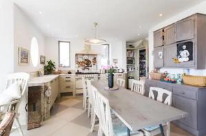 a kitchen with a table and chairs in a room at Captivating 7-Bed House in Bristol in Bristol