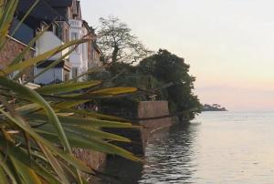 a building next to a body of water at Captivating 7-Bed House in Bristol in Bristol