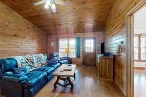 a living room with a blue couch and a table at Grandfathers Vista in Newland