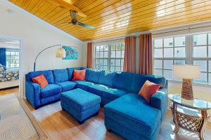 a living room with a blue couch and a table at Paradise on Packer in Key West