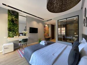 a bedroom with a large bed with a desk and a sink at Retreat Apartments in Tirana