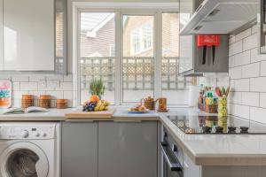 a kitchen with a counter top with a dishwasher at Tideway in Whitstable