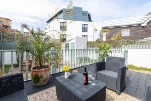 a patio with a table and chairs on a balcony at Tideway in Whitstable