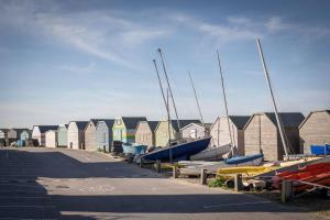a bunch of boats are lined up in a harbor at Tideway in Whitstable