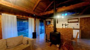 a living room with a couch and a fireplace at Jaśkowa Stodoła in AdamÃ³w