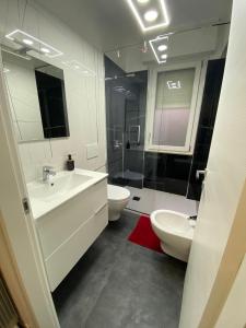 La salle de bains est pourvue de 2 lavabos, de toilettes et d'une douche. dans l'établissement Affittacamere da Gigi, à Vintimille