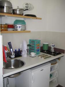 a kitchen counter with a sink and a stove at Gioiosa Marea Appartamento per 4 con vista sulle Eolie Casa Spisidda "Panarea" in Gioiosa Marea