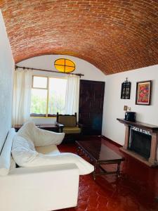 uma sala de estar com um sofá e uma lareira em LA ERMITA "Antigua casa de Cantinflas" em San Miguel de Allende