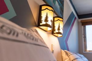 a bedroom with two lights on the wall at Astoria Hotel in Jasper