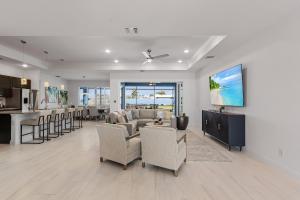 a living room with a couch and chairs and a kitchen at BIG WATER VIEW!, Heated Saltwater Pool and Spa - Villa Manatees Crossing - Roelens in Matlacha